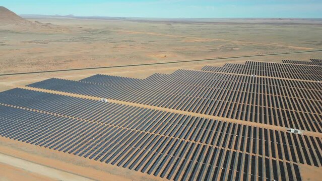 Slow drift over grid of solar panels on PV electrical power station