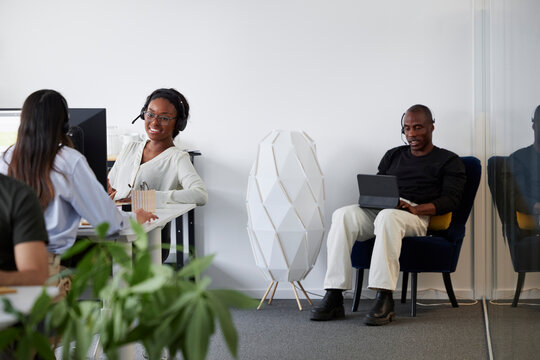 People sitting and using computers in office