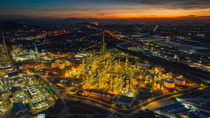 Fototapeta na wymiar Aerial view of the morning of the oil refinery from the drone of the tower of the Petrochemistry industry in the oil​ and​ gas​ ​industry with​ cloud​ sun orange​