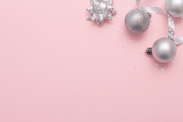 Christmas background christmas silver tree toys at the pink background.,copy space,top view photo.