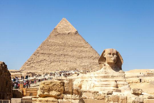 Tourists at The Sphinx and Pyramid of Chephren against clear blue sky