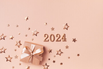 2024 gift or present box with golden confetti stars top view. Christmas and New Year background.