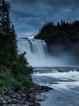 Tannforsen waterfall near trees against sky