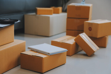 Entrepreneurs Small Business SME Independent men work at home Use smartphones and laptops for commercial checking, online marketing, packing boxes, SME sellers, concept, e-commerce team, online sales