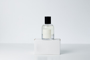 Perfume in a folded bottle with a box on a white background