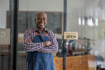 A healthy retired black senior man stands proudly at his new private business. Startup business...