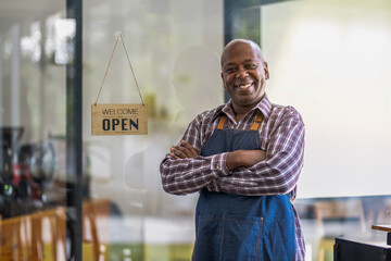 A healthy retired black senior man stands proudly at his new private business. Startup business...