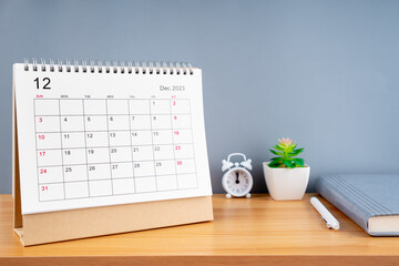 December 2023, Monthly desk calendar for 2023 year on wooden table.