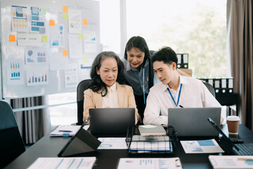 Office colleagues have a casual discussion. During a meeting in a conference room, a group of business teem .