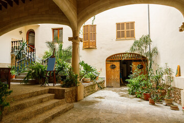 The typical cozy courtyard with lots of plants in pots in Fornalutx