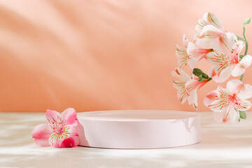 Podium with pink lily flowers and aesthetic shadows. Cute lovely showcase for cosmetic, perfume, design and product presentation. Spring and summer gentle background