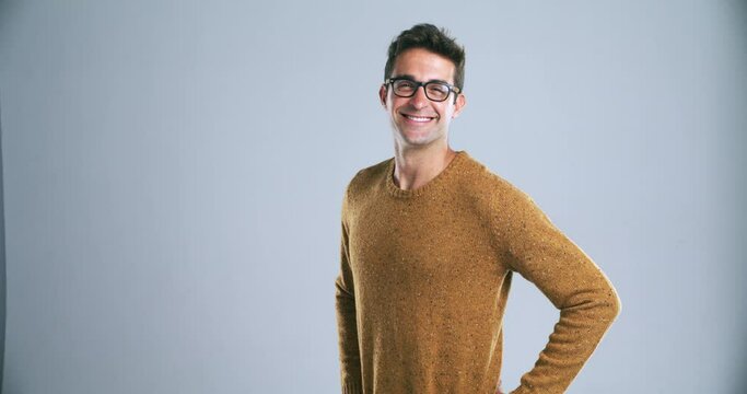 Happy, nerd and man with glasses and confidence in vision, eye care and smile in fashion mockup. Optometry, eyewear or portrait of person or geek with frame and lens in grey background or studio