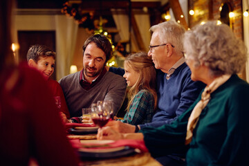 Happy extended family having dinner together on Christmas Eve.