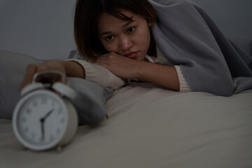 asian woman in bed late trying to sleep suffering insomnia, sleepless or scared in a nightmare,...