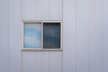 Residential building wall with slide glass window frame. Building exterior structure photo.