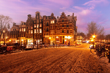 Snowy Amsterdam at sunset in the Netherlands
