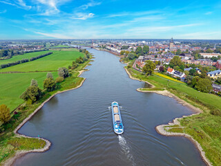 Cargo ship cruising on the river IJssel near Zutphen in the Netherlands