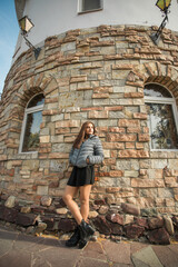 Fototapeta na wymiar Portrait of diversity young beautiful confident Indian Asian woman in fall season brick building background. Happy and natural smiling female. Generation z and gen z youth concept