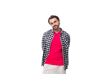 Fototapeta premium portrait of a young caucasian handsome guy with a beard and styled hair dressed in a plaid shirt