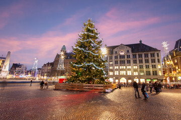 Amsterdam in christmas time on the Dam square in the Netherlands at sunset