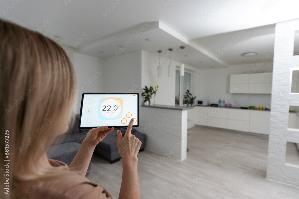 Poster controlling home with a digital touch screen panel installed on the wall in the living room. concept