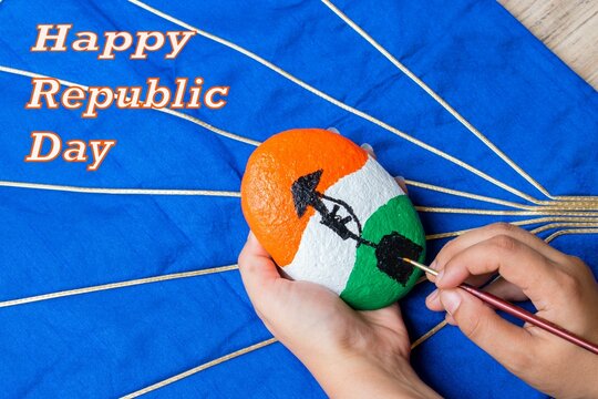 Happy Republic Day of India . Hand painting stone with flag tricolor and " amar jawan jyoti " symbol . blue background	. copy space