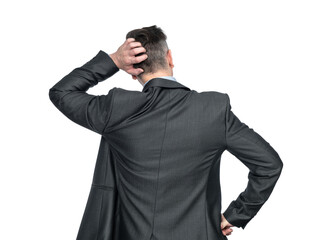Rear view, a man in a dark suit thinks and scratches his head with his hand, isolated on a...