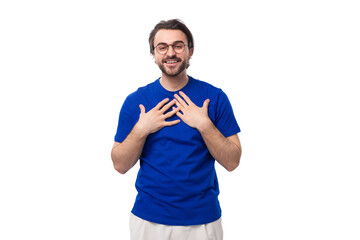 a young kind Caucasian man with dark well-groomed hair and a beard in a blue T-shirt