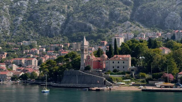 Tower St. Matthias Church in Dobrota town, Montenegro. Photo shot from a passing ship 4K.