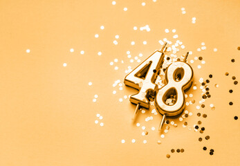 48 years birthday celebration festive background made with golden candle in the form of number...