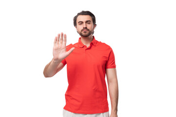 young handsome brunette man with a beard is dressed in a standard red t-shirt on a white background...