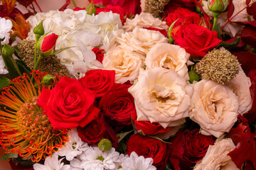 Autumn bouquet of red and white roses, hydrangeas, chrysanthemums as a background.
