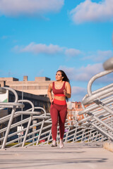 Fit woman running along an urban park