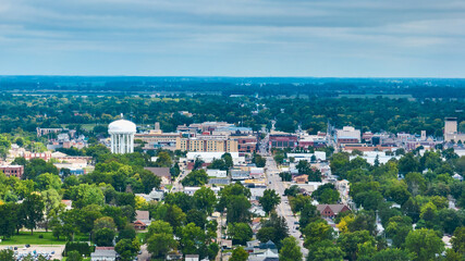 Muncie Indiana aerial of city with downtown buildings and water tower on overcast summer day
