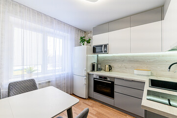 interior apartment kitchen and dining room, refectory area, cooking equipment, table furniture, stove