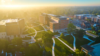 Bright college campus aerial Ball State University on golden dawn sunrise with fog Muncie, IN