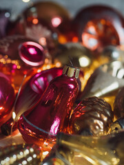 Vertical close up of vintage blown glass Christmas ornaments illuminated with electric lights.