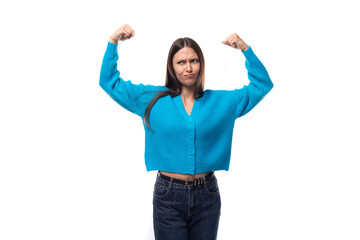 young pretty european brunette woman dressed in a blue button-down sweater actively gesturing on a white background with copy space