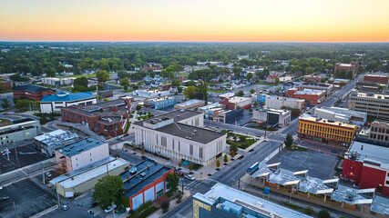 Muncie Indiana downtown aerial buildings with central courthouse and golden yellow dawn
