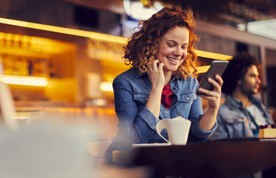 Stylish Woman Enjoying a Hot Cup of Coffee in a Cozy Cafe