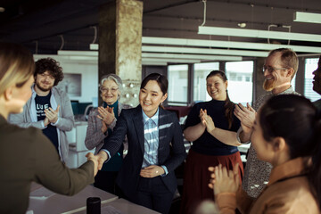 Diverse Team Celebrating Colleagues Achievement