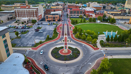 Muncie, IN aerial roundabout with Passing of the Buffalo statue and Canan Commons Park at sunset