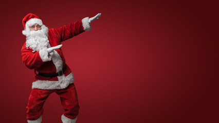 Fototapeta na wymiar Santa Claus dancing, getting into the festive Christmas spirit
