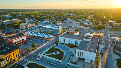 Courthouse, Muncie, IN at sunset with golden sun setting in aerial of downtown buildings - obrazy, fototapety, plakaty