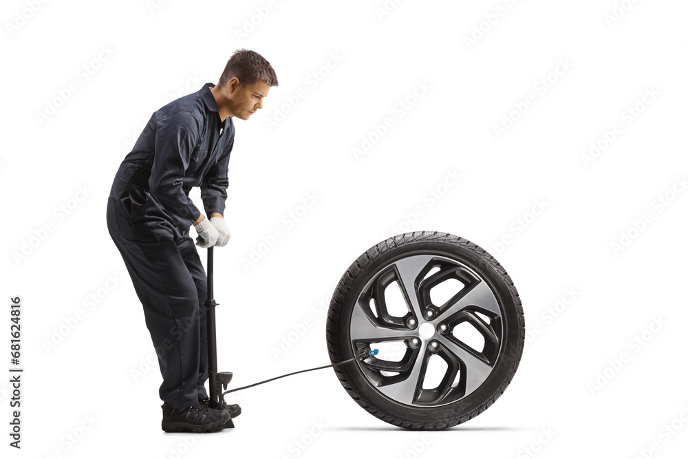 Canvas Prints car mechanic using a manual pump for a tire