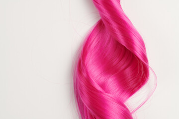 Natural looking shiny hair pink bright color, cosplay wig on a white background