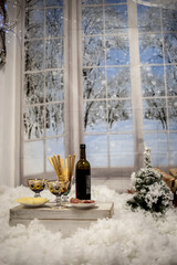 Two wine Glasses With Christmas Decoration and snow window 