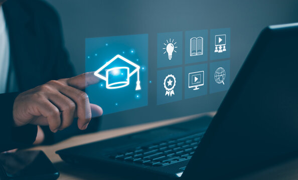 Concept of modern educational technology learning curriculum ,Human hand taps graduation cap icon to enter internet website to learn the educational curriculum to develop,skills with virtual screen