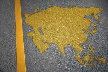 yellow map of asia on asphalt road near yellow line.