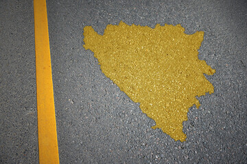 yellow map of bosnia and herzegovina country on asphalt road near yellow line.